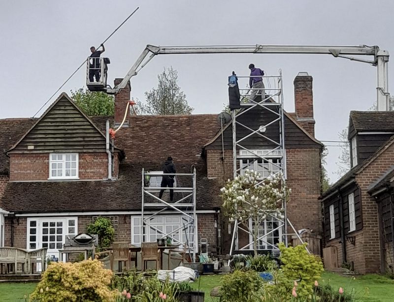 The Roof Moss Cleaners using cherry picker and scaffolding to clean roof safely and professionally in Chalford, Gloucestershire