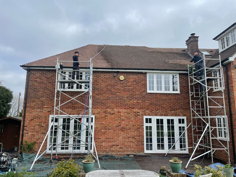 Roof cleaning carried out safely from scaffold towers by The Roof Moss Cleaners in Chalford